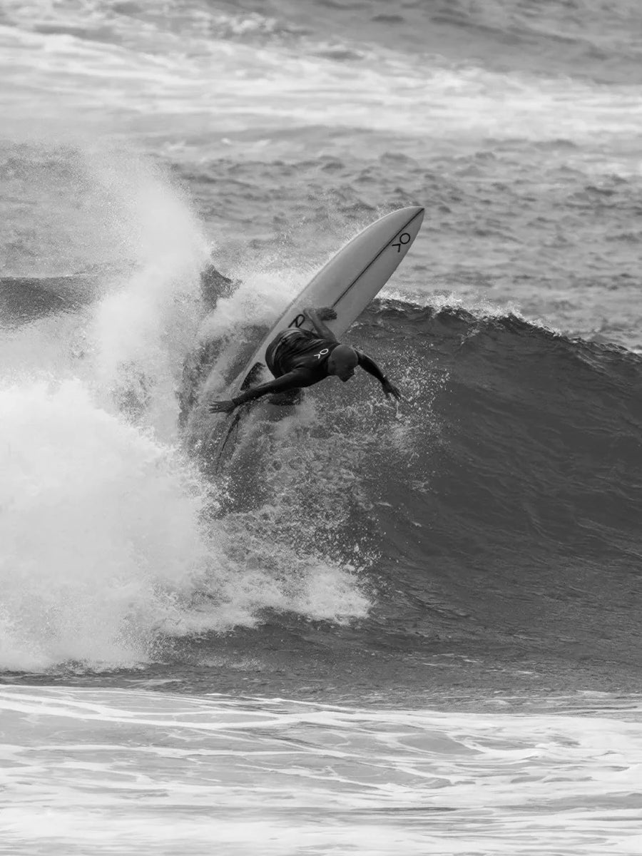 Surfer riding a wave on the Firewire Boss Up Ibolic Volcanic surfboard