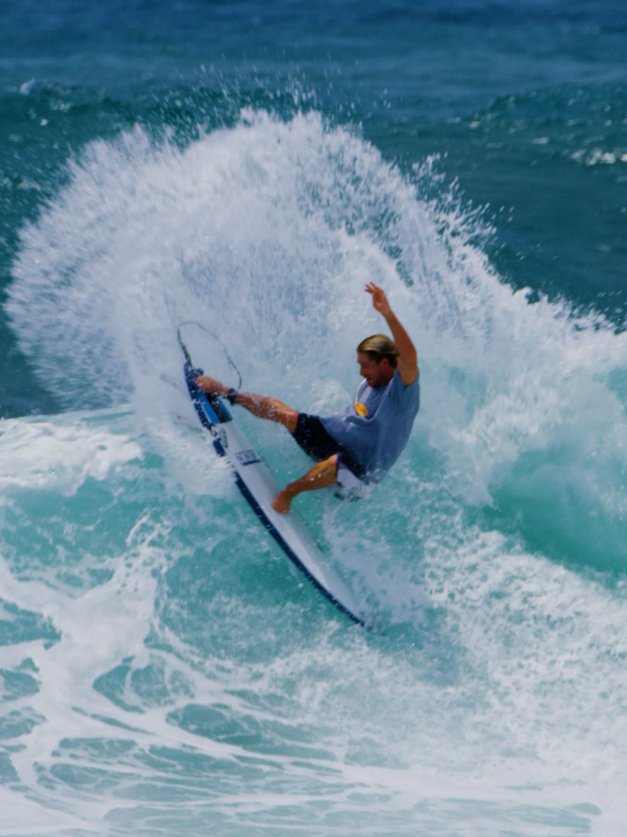 Surfer carving a turn on the Hayden Shapes DarkNoiz surfboard