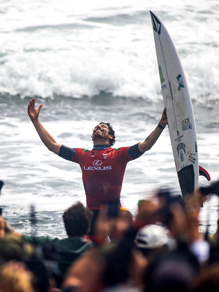 Yago Dora celebrating a World Title win while holding the Lost Formula 1 Round Pin surfboard