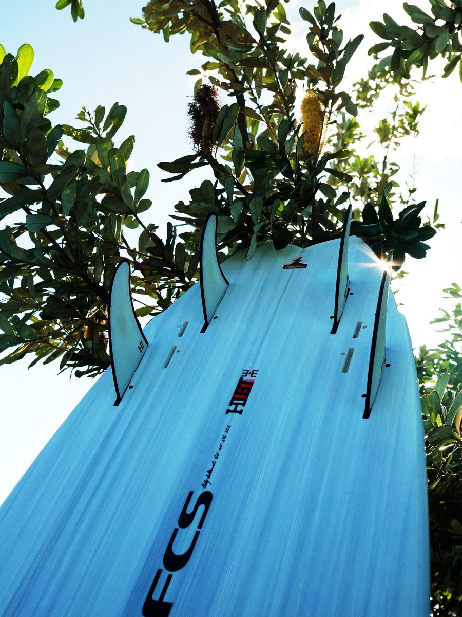Close-up of the HIBT 3+3 Thunderbolt surfboard fin cluster and rail