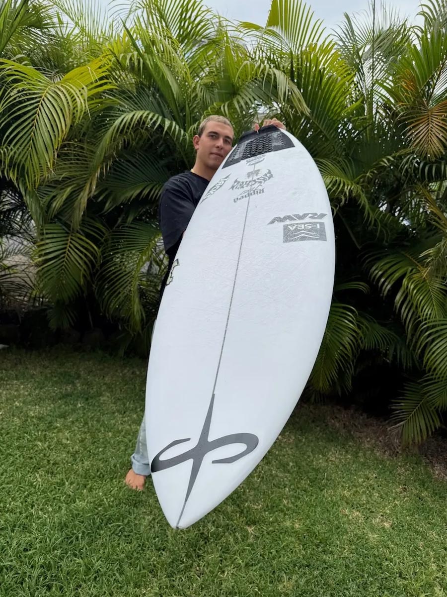 Surfer holding the Lost Big Rig Round surfboard outdoors