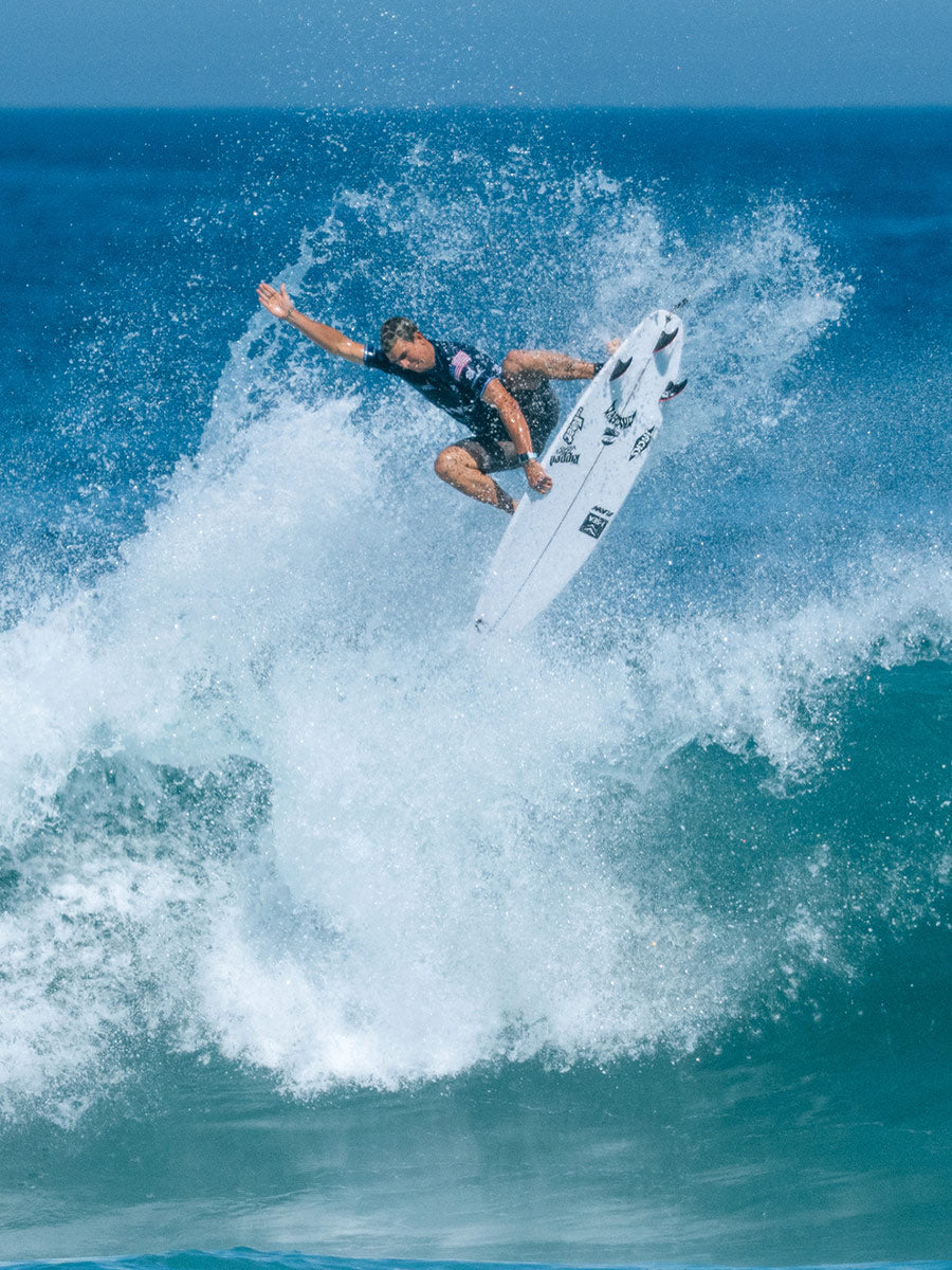 Surfer performing an aerial on the Lost Formula 1 Squash surfboard