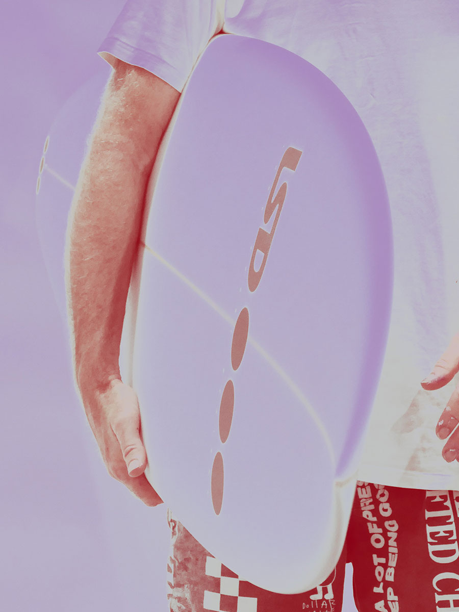 noa deane holding the lsd noa 2 surfboard