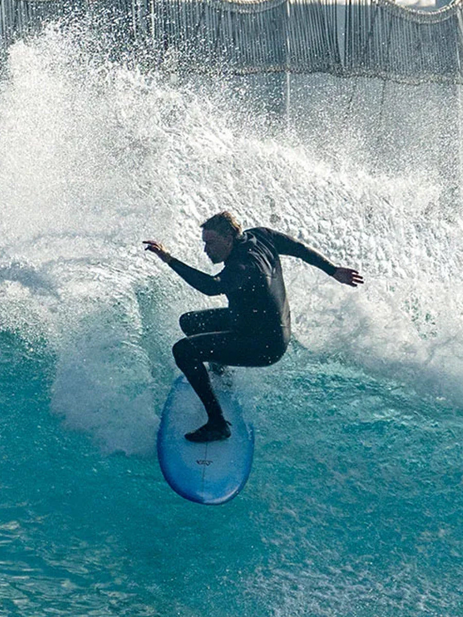 Surfer riding the Lost Quiver Killer surfboard on a breaking wave