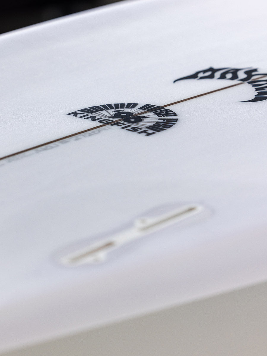 Close-up of Lost RNF 96 King Fish surfboard deck logo and fin plug