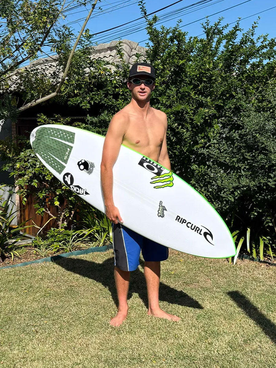 Surfer holding the Lost Quiver Killer Light Speed II surfboard outdoors
