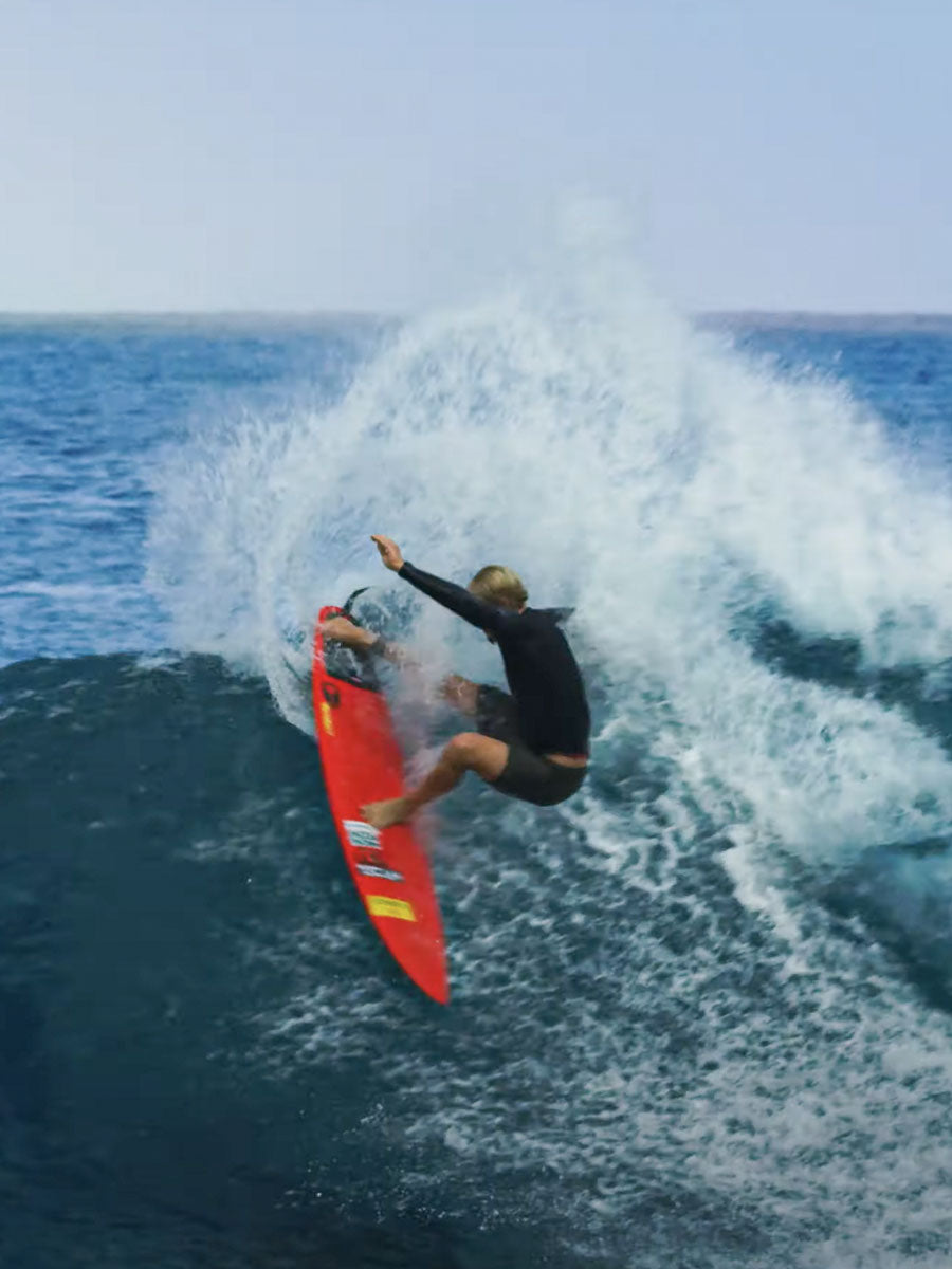 John John Florence surfing on the Pyzel Red Tiger surfboard, carving a wave